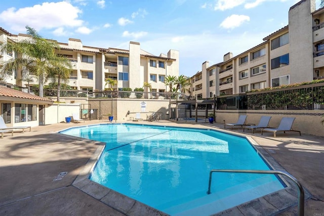 pool featuring a patio and fence