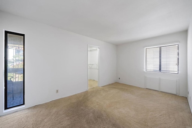 empty room featuring light carpet