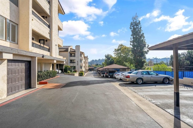 view of asphalt road with a residential view