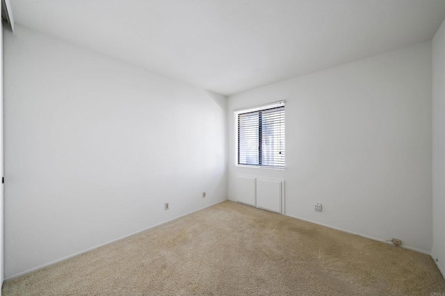 unfurnished room featuring light colored carpet
