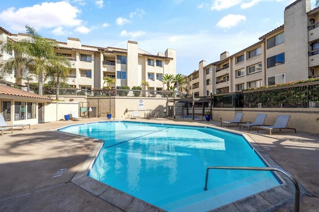 community pool with a patio area