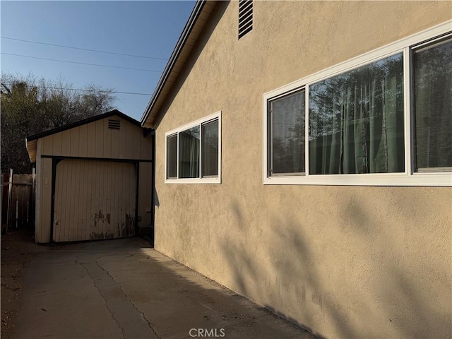 view of home's exterior featuring an outbuilding and a garage