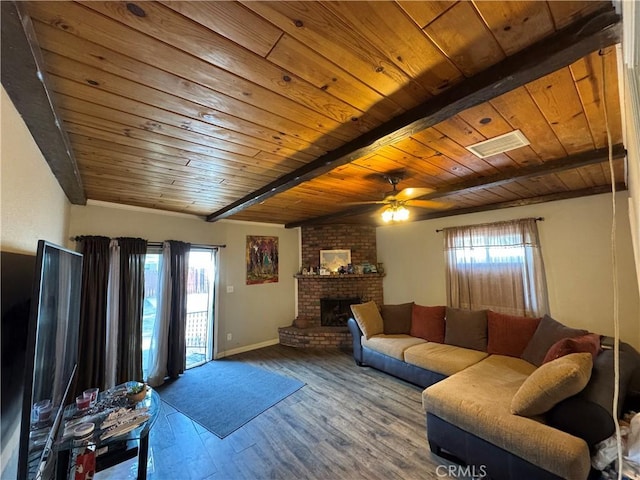 living room with a fireplace, plenty of natural light, beamed ceiling, and wood ceiling