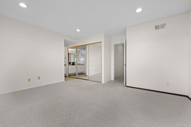 unfurnished bedroom featuring light carpet