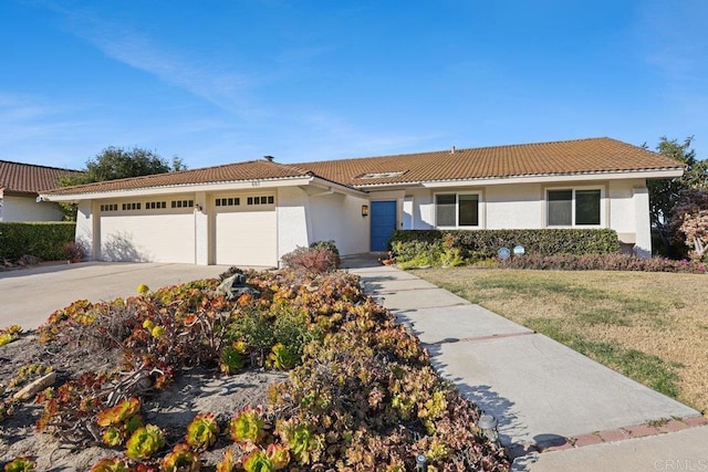 view of front of house featuring a garage and a front lawn