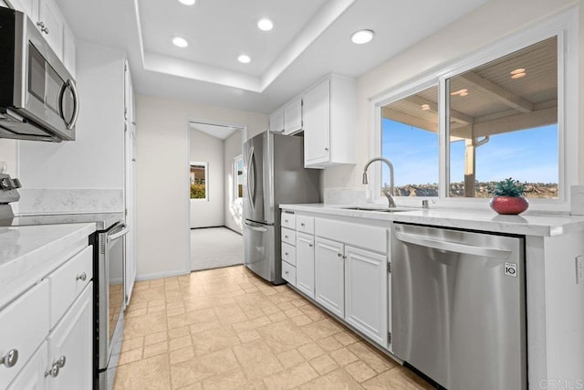 kitchen with sink, stainless steel appliances, and white cabinets