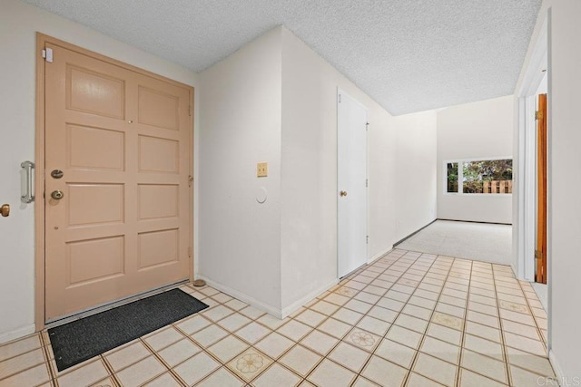 foyer with a textured ceiling