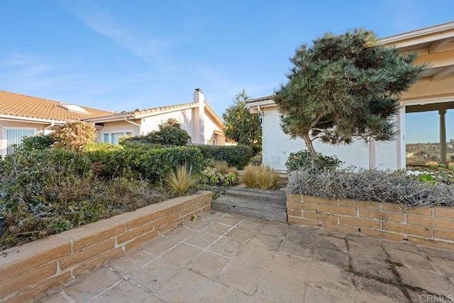 view of side of home with a patio