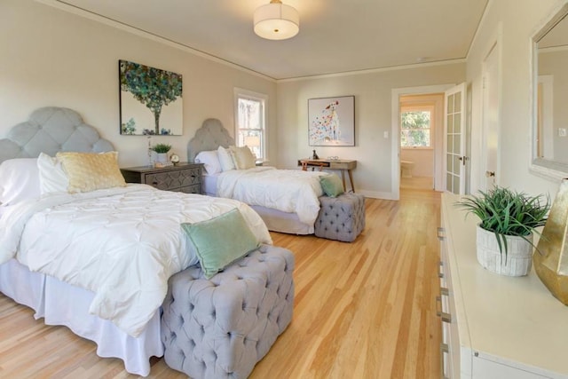 bedroom with hardwood / wood-style flooring and ornamental molding