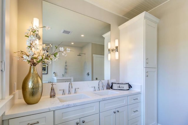 bathroom with walk in shower and vanity