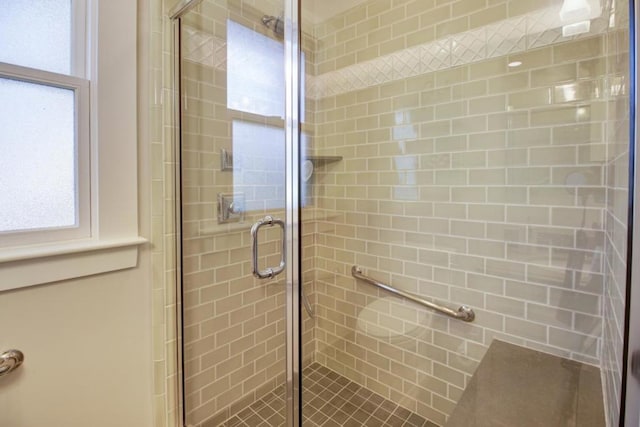 bathroom with a shower with door