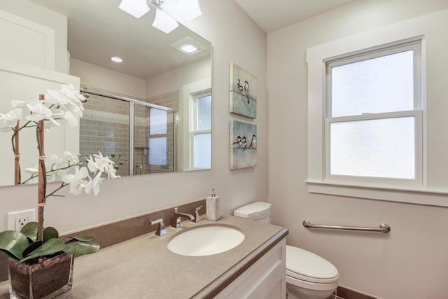 bathroom featuring toilet, walk in shower, and vanity