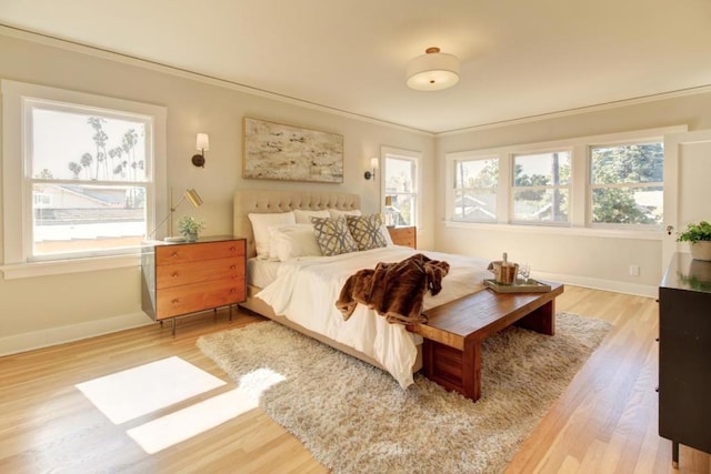 bedroom featuring wood-type flooring and crown molding