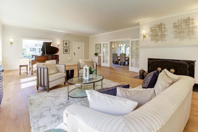 living room featuring light wood-type flooring and ornamental molding