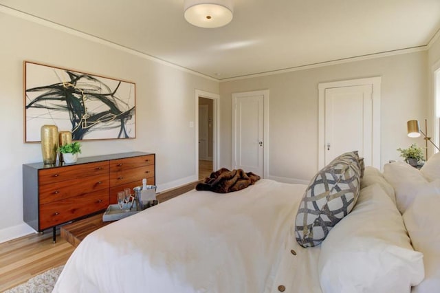 bedroom with crown molding and hardwood / wood-style floors