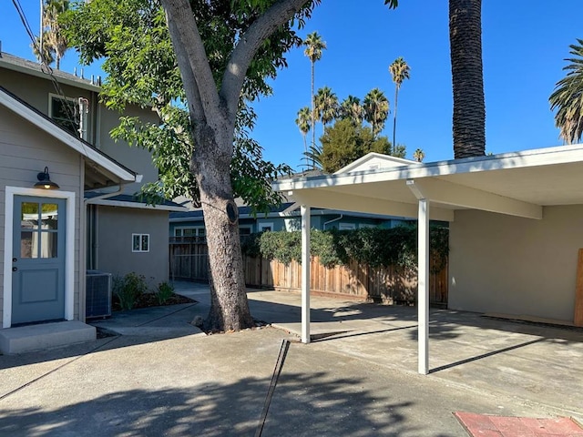 view of parking / parking lot featuring a carport