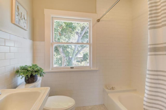 full bathroom featuring tile patterned floors, shower / tub combo, sink, tile walls, and toilet