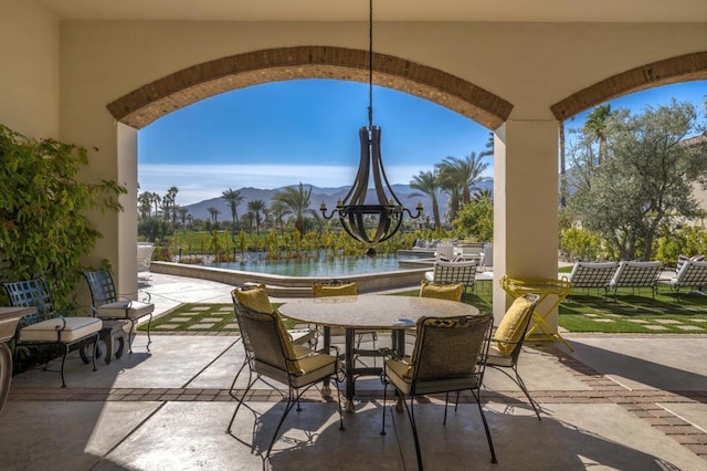 view of patio / terrace with a water and mountain view