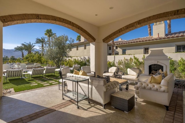 view of patio / terrace with an outdoor living space with a fireplace