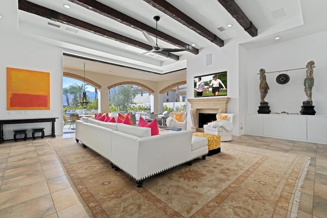 living room featuring ceiling fan, beam ceiling, and light tile patterned floors