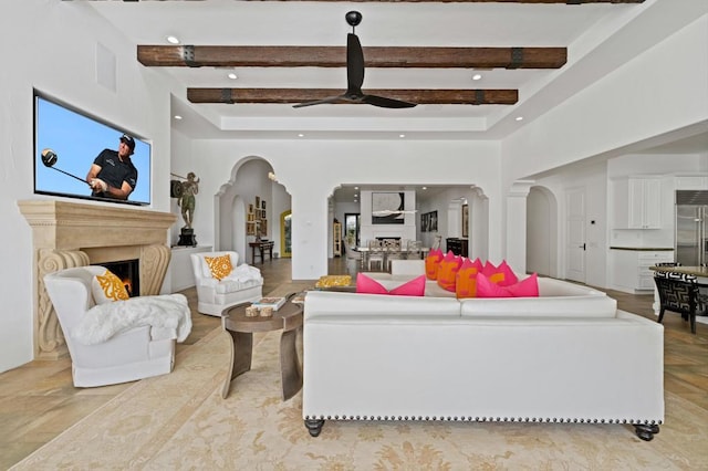 living room featuring beam ceiling and ceiling fan