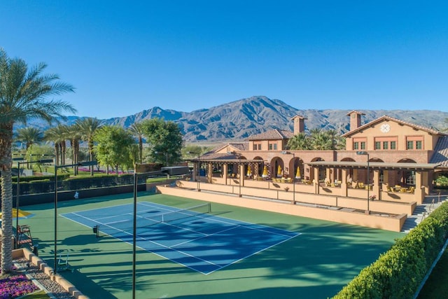 view of tennis court featuring a mountain view and a gazebo