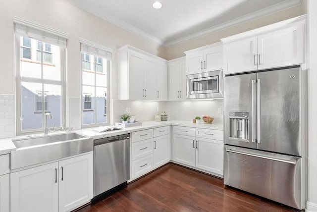 kitchen with stainless steel appliances, sink, white cabinets, and dark hardwood / wood-style floors