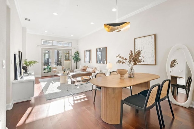 dining room with ornamental molding, dark hardwood / wood-style floors, and french doors