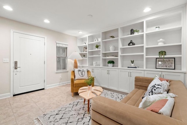 sitting room featuring built in shelves and light tile patterned floors