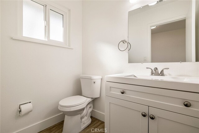 266 E Fig Ln, Corning, CA 96021 - bathroom featuring hardwood / wood-style flooring, vanity, and toilet