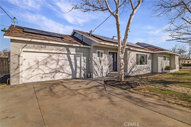 266 E Fig Ln, Corning, CA 96021 - ranch-style house featuring a garage and solar panels