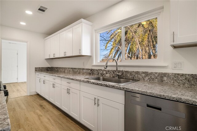 266 E Fig Ln, Corning, CA 96021 - kitchen featuring light hardwood / wood-style flooring, dishwasher, light stone counters, white cabinets, and sink