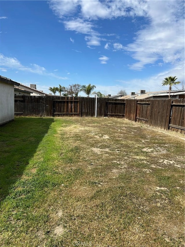 view of yard with a fenced backyard