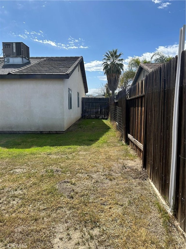 view of yard featuring a fenced backyard and central air condition unit