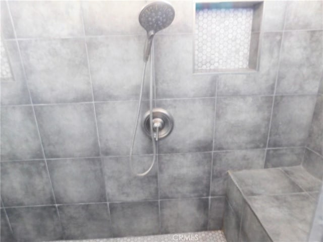 bathroom with tiled shower