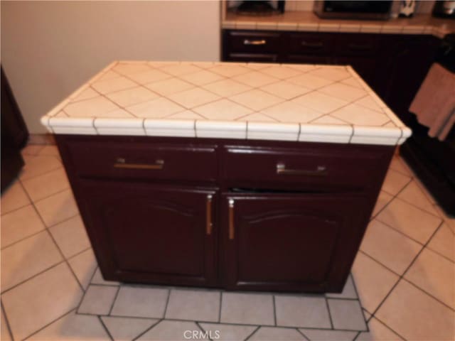 kitchen featuring tile counters and light tile patterned floors