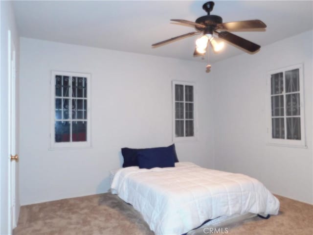 bedroom with ceiling fan and carpet flooring