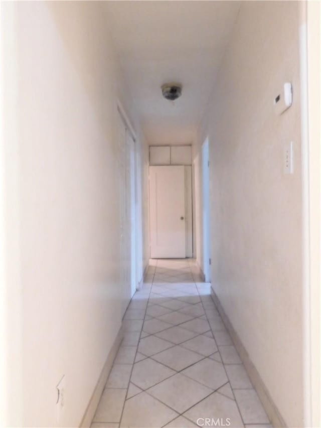 hall featuring light tile patterned flooring