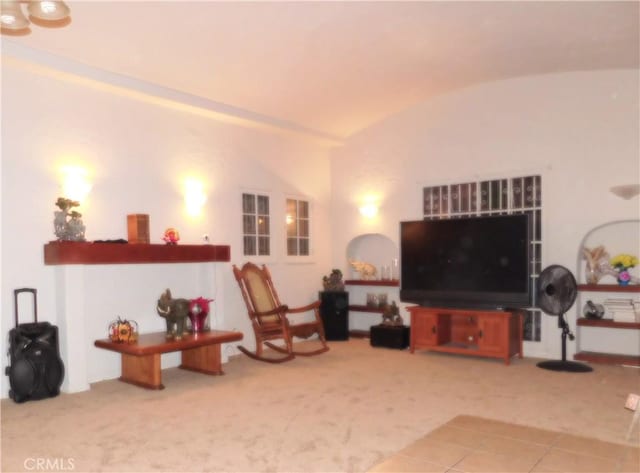 living room with carpet floors and vaulted ceiling