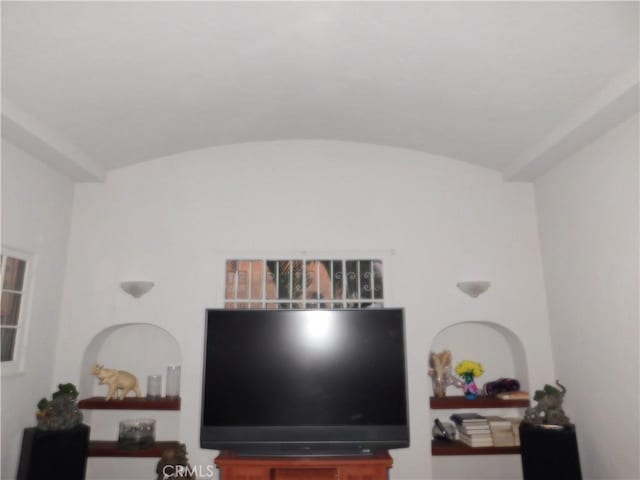 living room featuring lofted ceiling