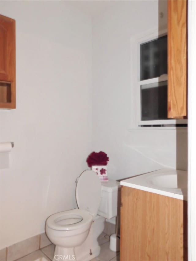 bathroom with tile patterned flooring, vanity, and toilet