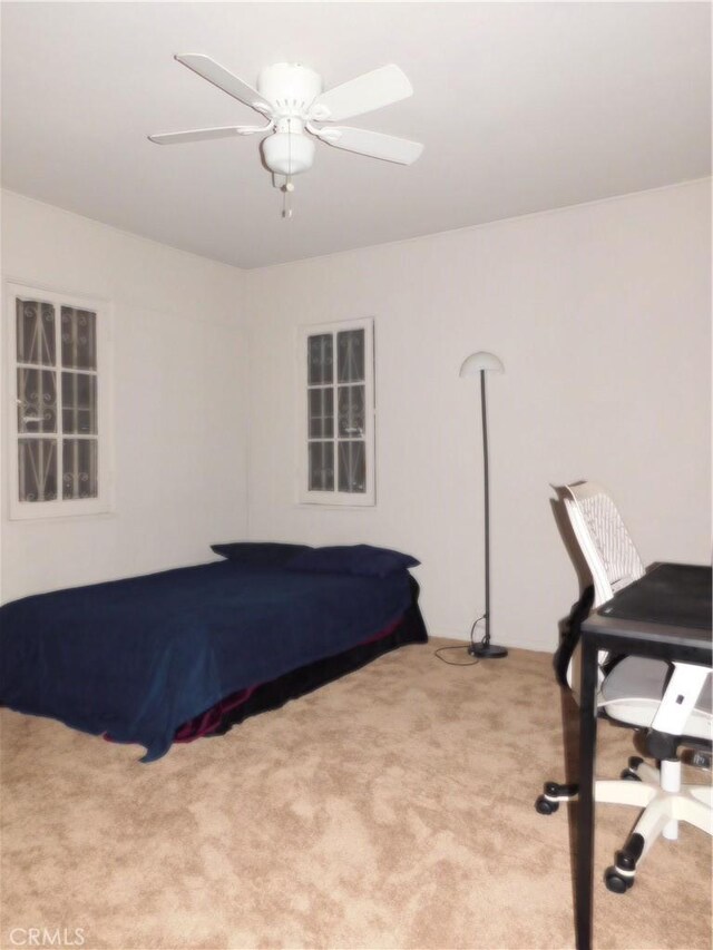 carpeted bedroom with ceiling fan