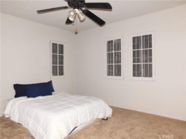 carpeted bedroom featuring ceiling fan