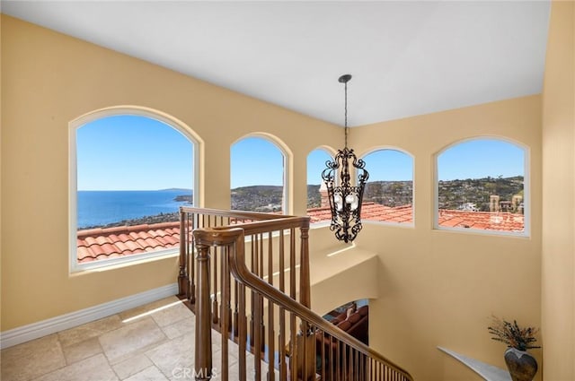 hallway featuring a chandelier and a water view