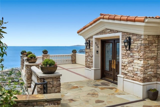 view of patio with a water view