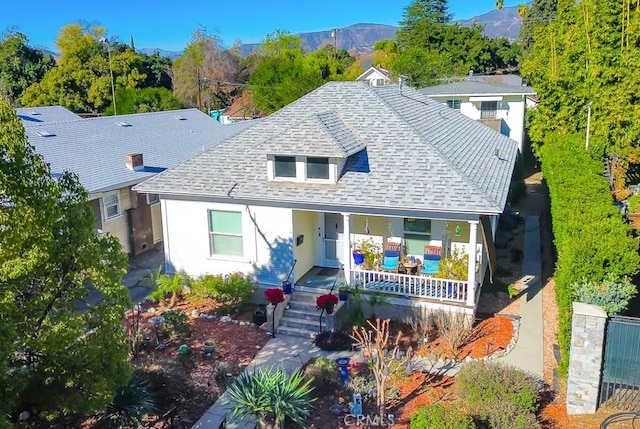 view of front of home with covered porch and a mountain view