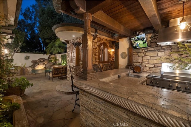 view of patio / terrace featuring area for grilling, sink, and a grill