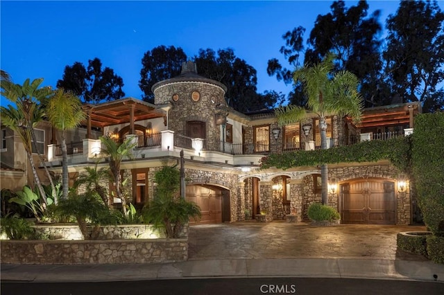 mediterranean / spanish-style home featuring a balcony and a garage