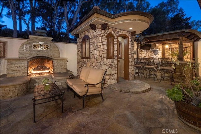 view of patio with an outdoor stone fireplace