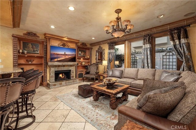 living room with a chandelier and a fireplace